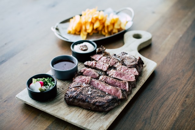 steak with fries and sauces