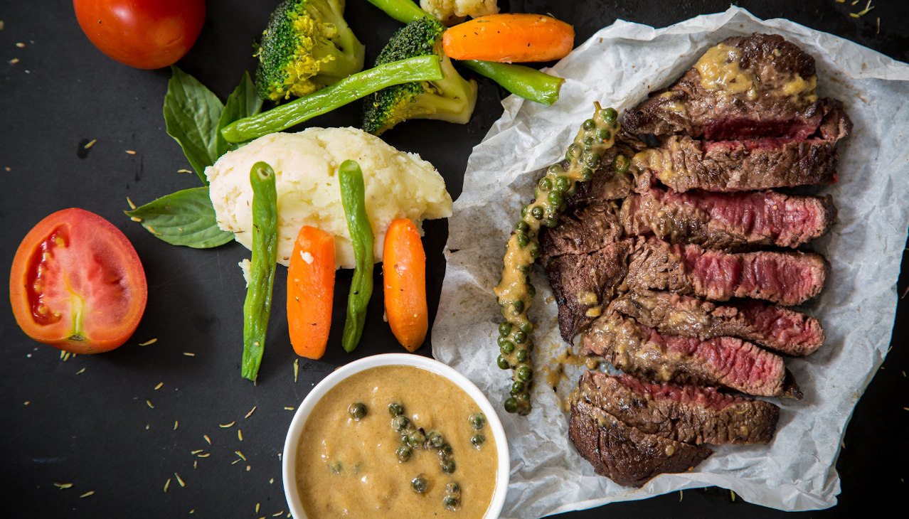 Beef served with salad and a dip.